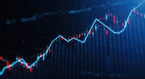 A dynamic visualization of financial market data. Candlestick charts illustrate stock price fluctuations, showcasing upward trends and potential investment growth opportunities. Image used to represent how time in the market beats timing the market.
