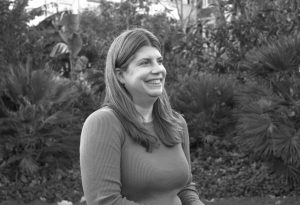 black and white headshot photo of jenny kenlin tribe's compliance officer. she is looking off to the right and laughing