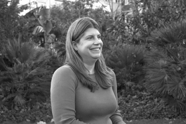 black and white headshot photo of jenny kenlin tribe's compliance officer. she is looking off to the right and laughing