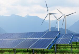 image depicting wind and solar renewable energy with mountains in the background